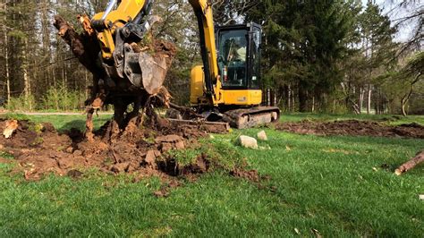 mini excavator digging stumps|mini tree stump removal.